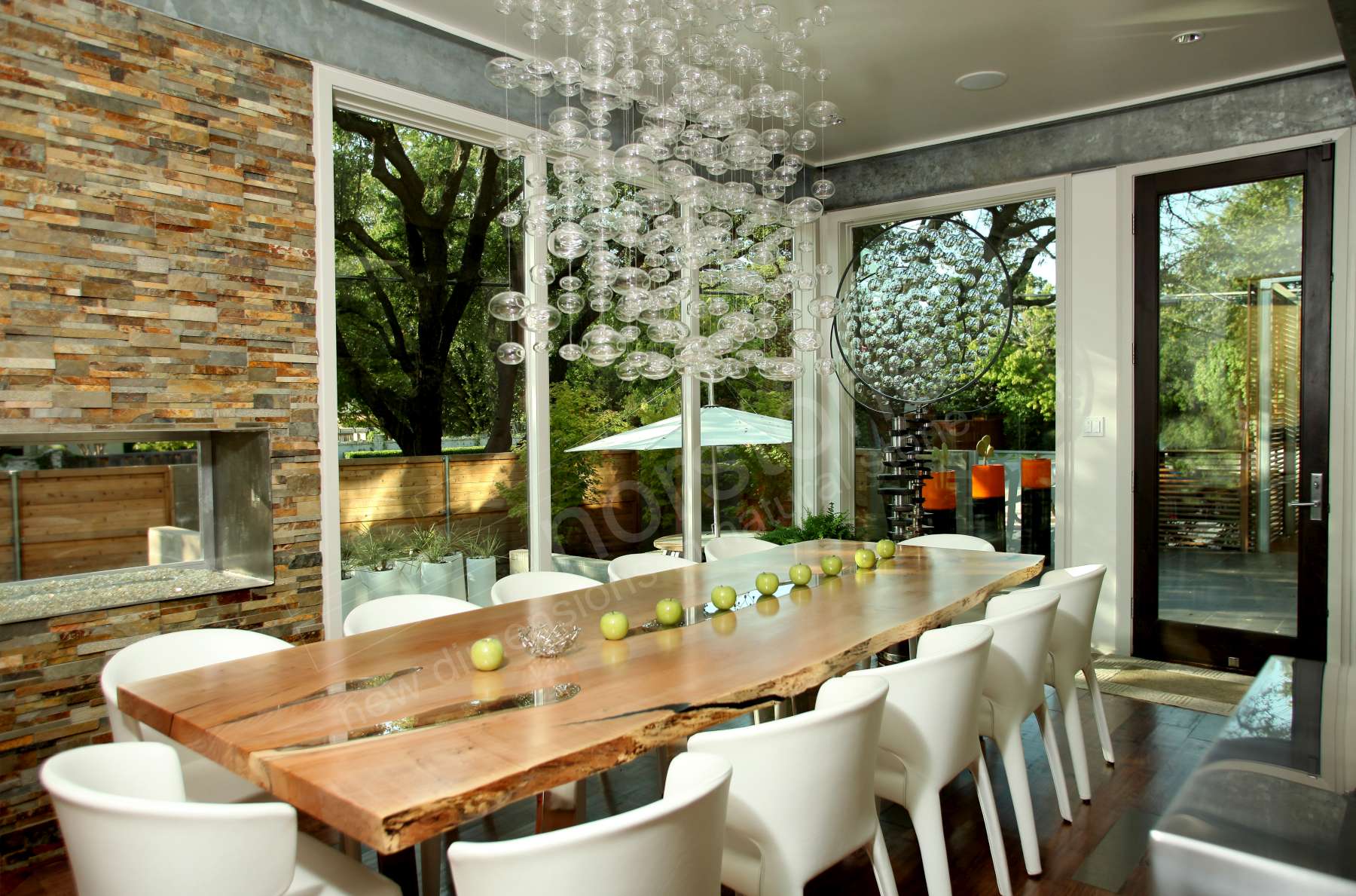 Norstone Natural Stone Veneer Ochre Rock Panels used on a fireplace in conjuction with a large dining room table made of solid wood with natural edges